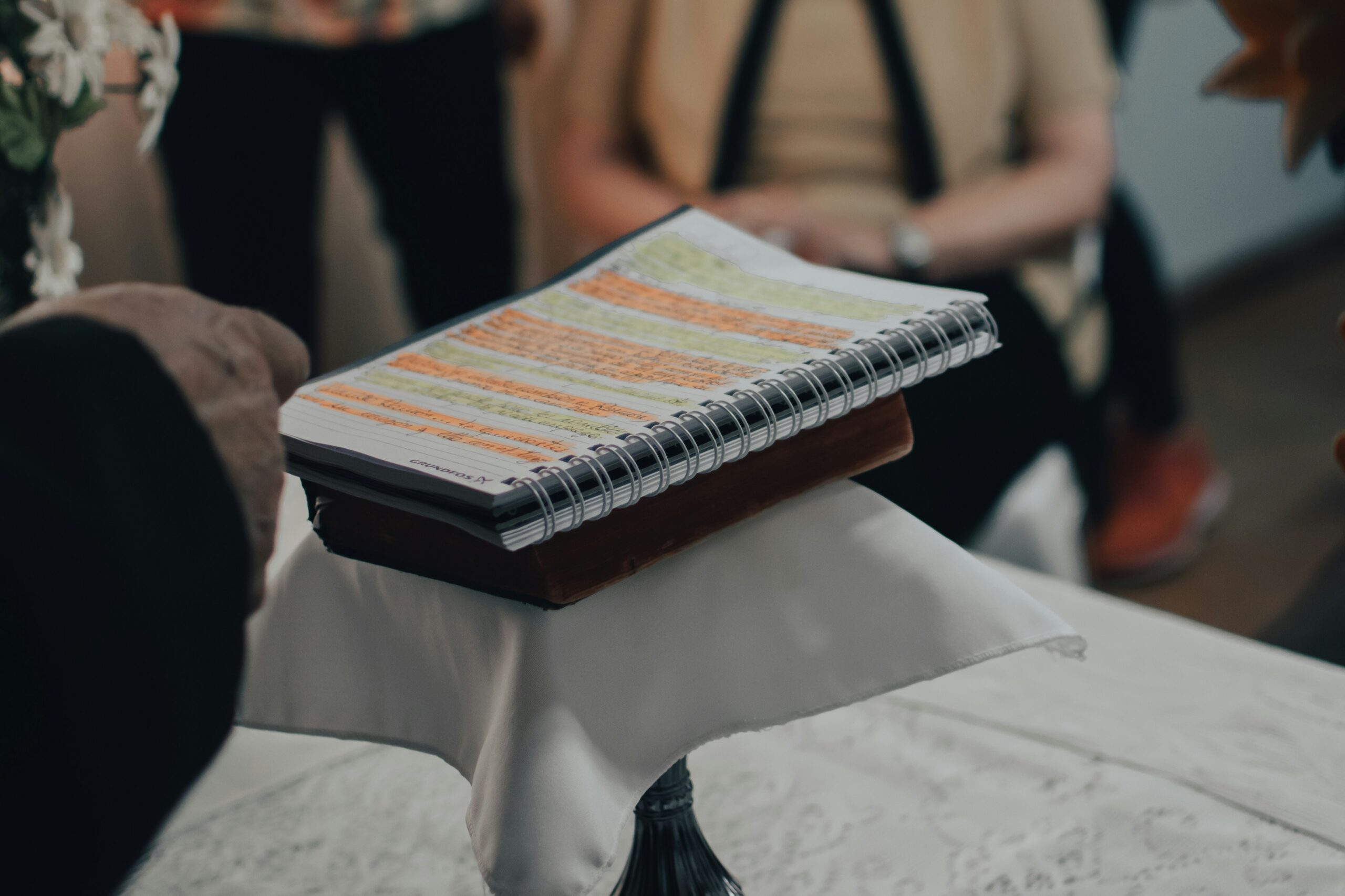 A photo by gaspar zaldo of a book with highlighted text on top of a lecturn